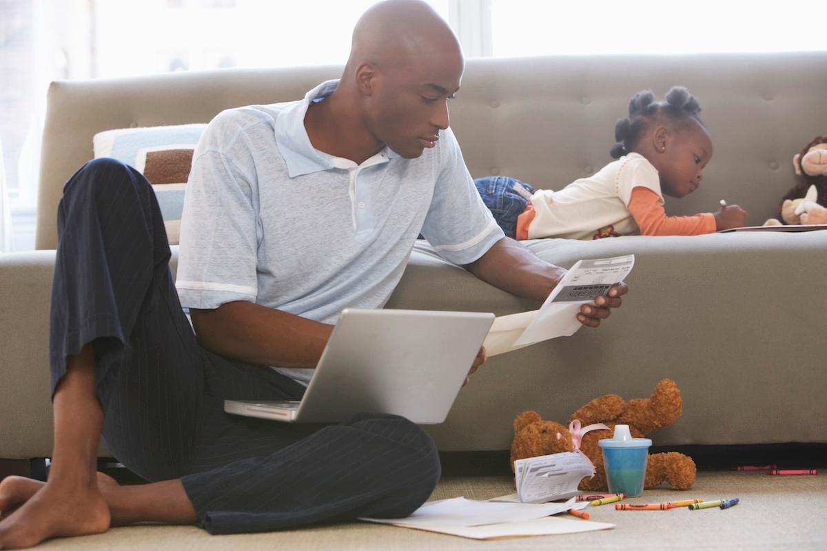 black father overlooking paperwork