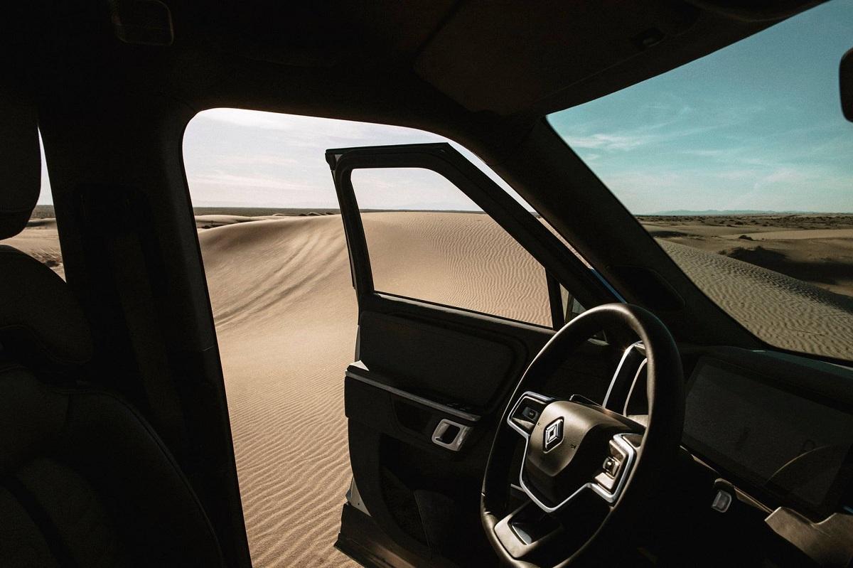 An interior shot of a Rivian car in a desert