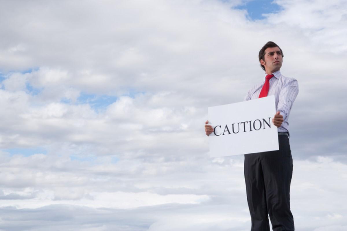 Man holding a caution sign