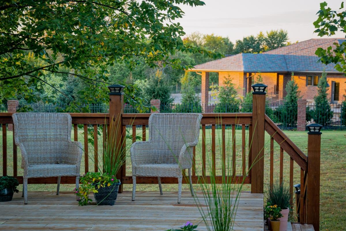 An outdoor deck space with two chairs at an Airbnb