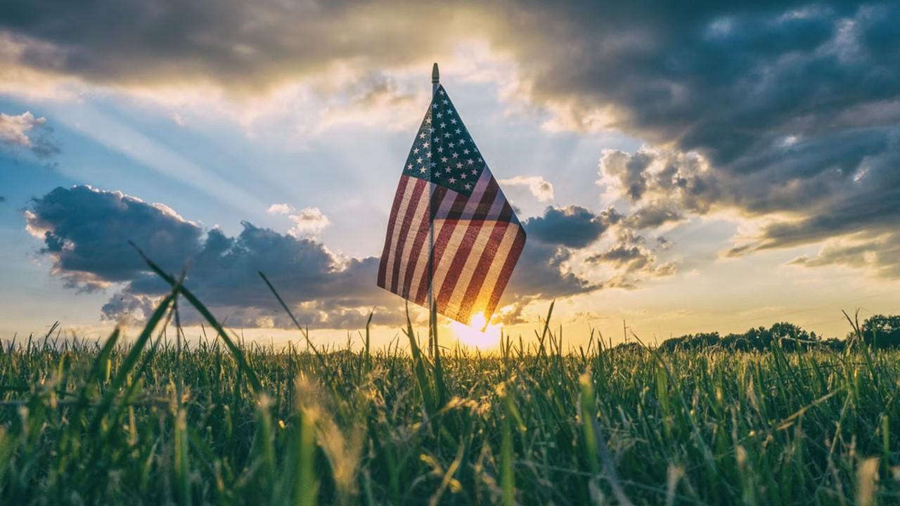 An American flag in a grass field