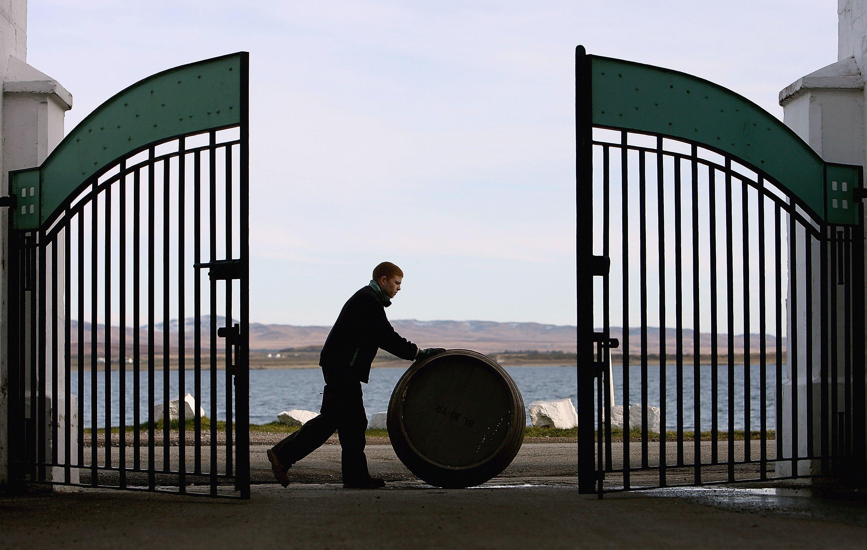 Man rolling barrel of oil