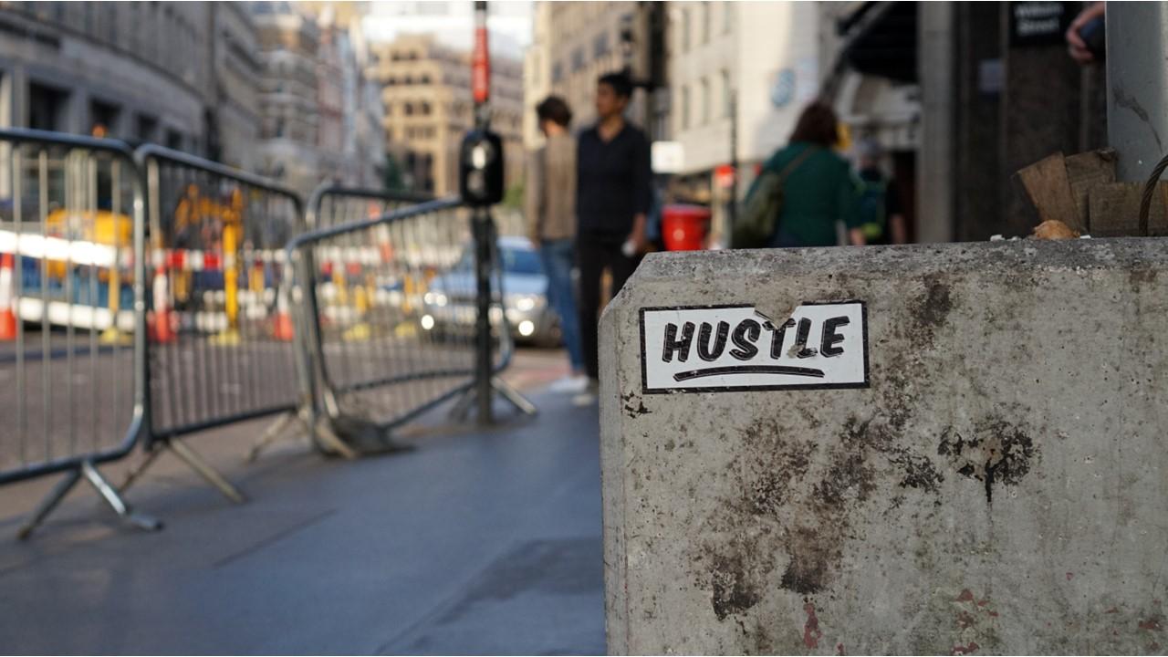 hustle sticker on concrete