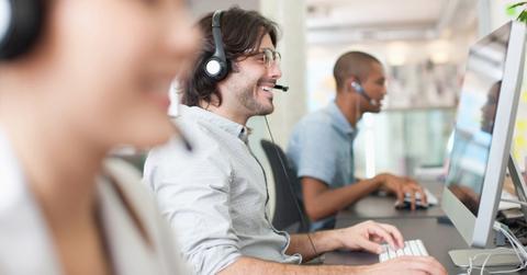 Credit repair specialists on the phone with clients.