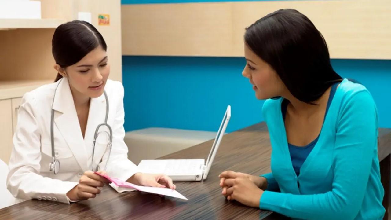 Doctor reviewing paperwork with a medical transcriptionist