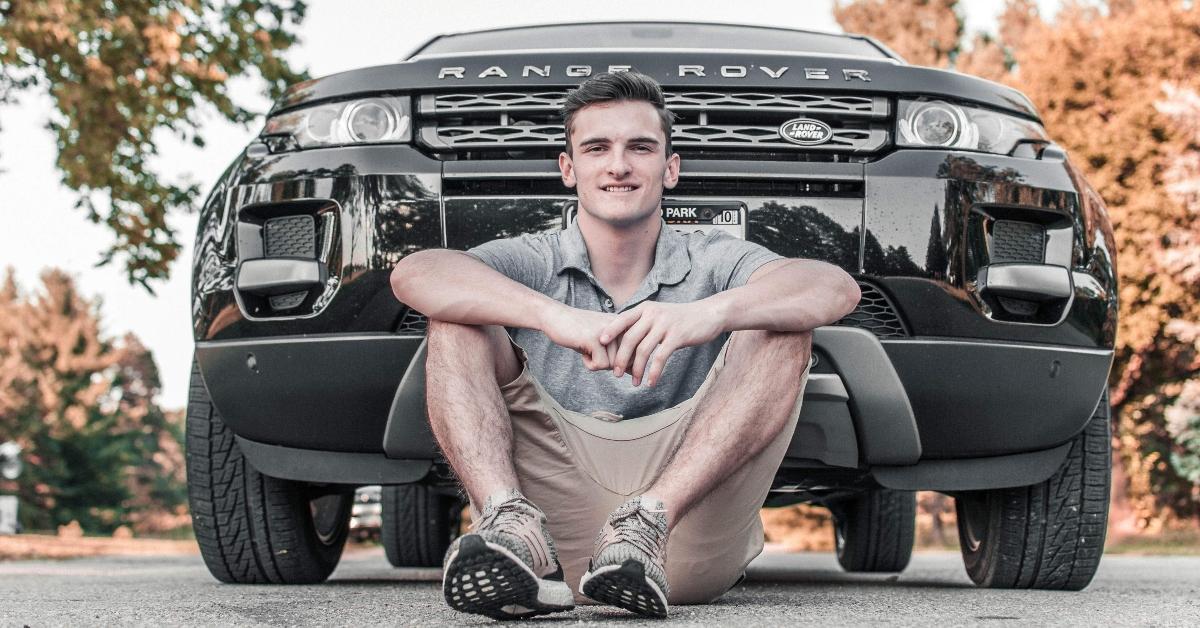 A man sitting in front of his Range Rover