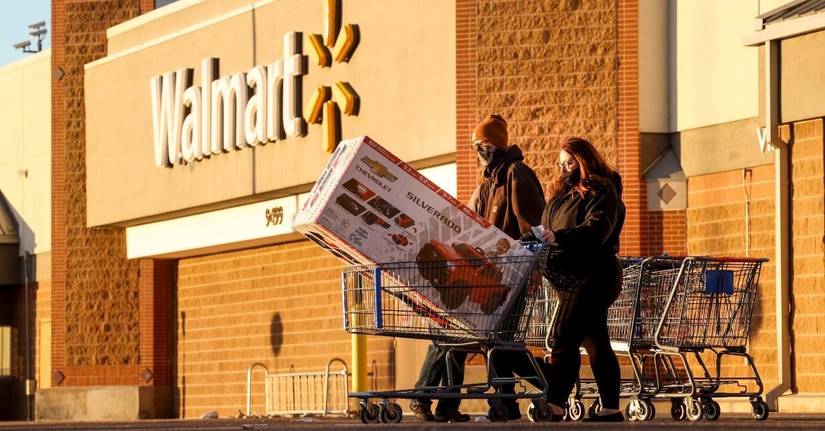 People pushing a cart outside of Walmart