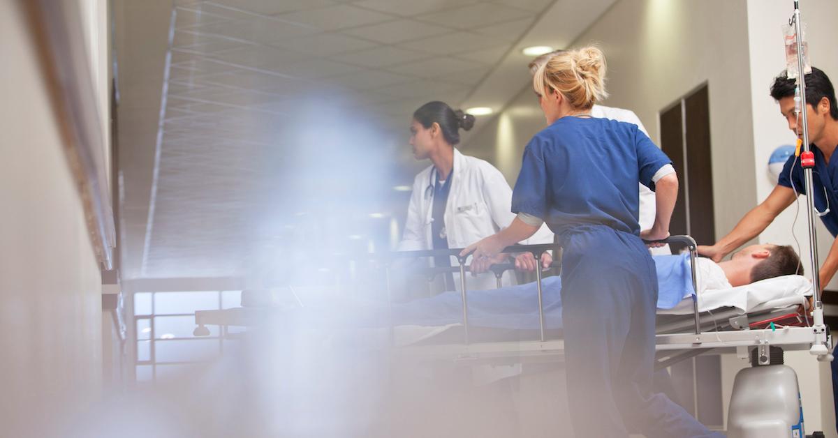 nurses moving a patient