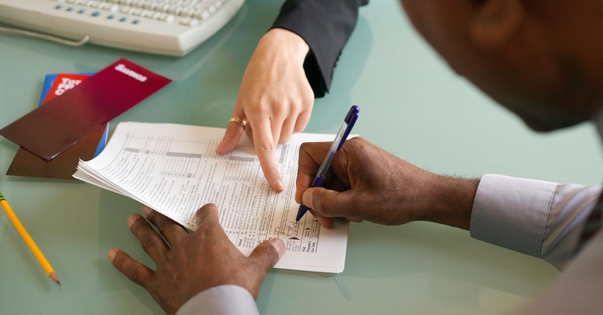 A man filling out tax forms