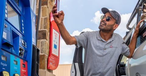 Person takes a picture of gas prices as prices hit record high