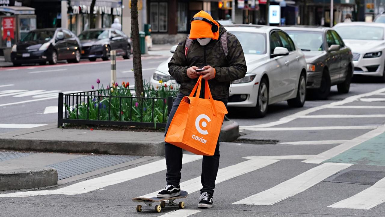 A Caviar delivery person