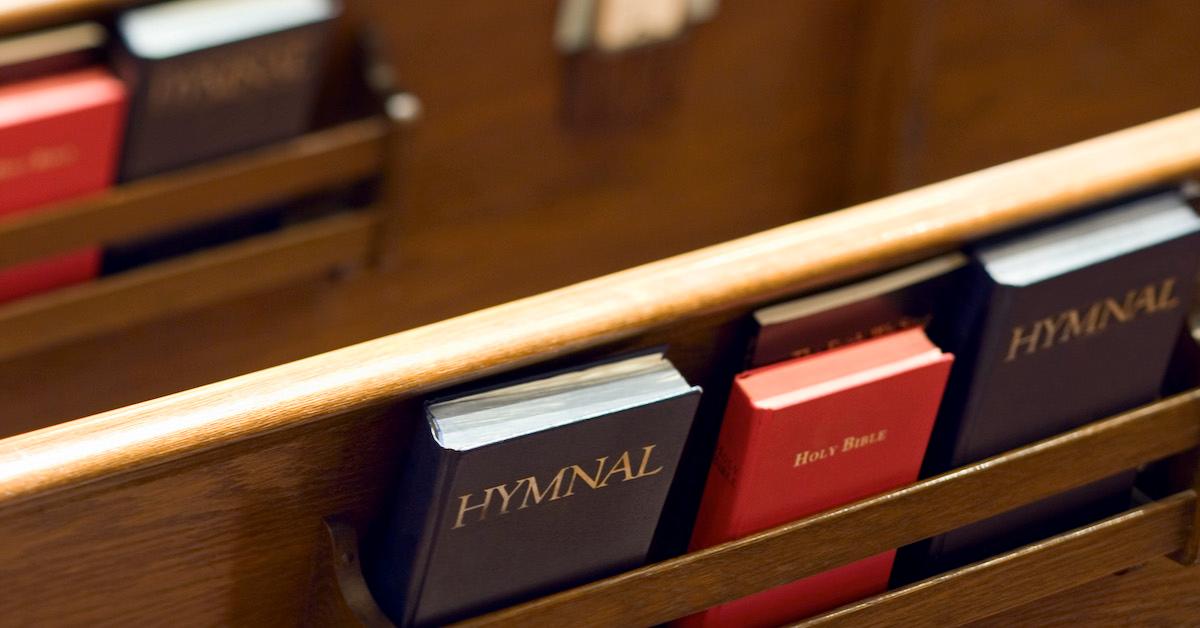 A church pew and hymnals