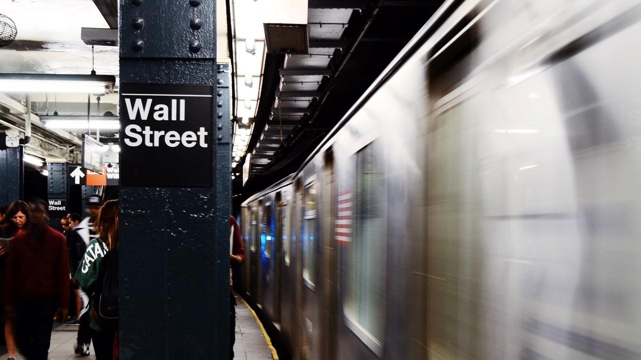 Wall Street sign in NYC subway station