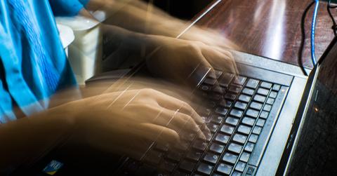 A person typing on a laptop