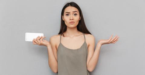 A woman holding an iPhone