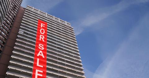 Apartment building with a for sale sign