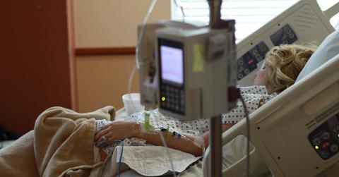 A person laying in a hospital bed