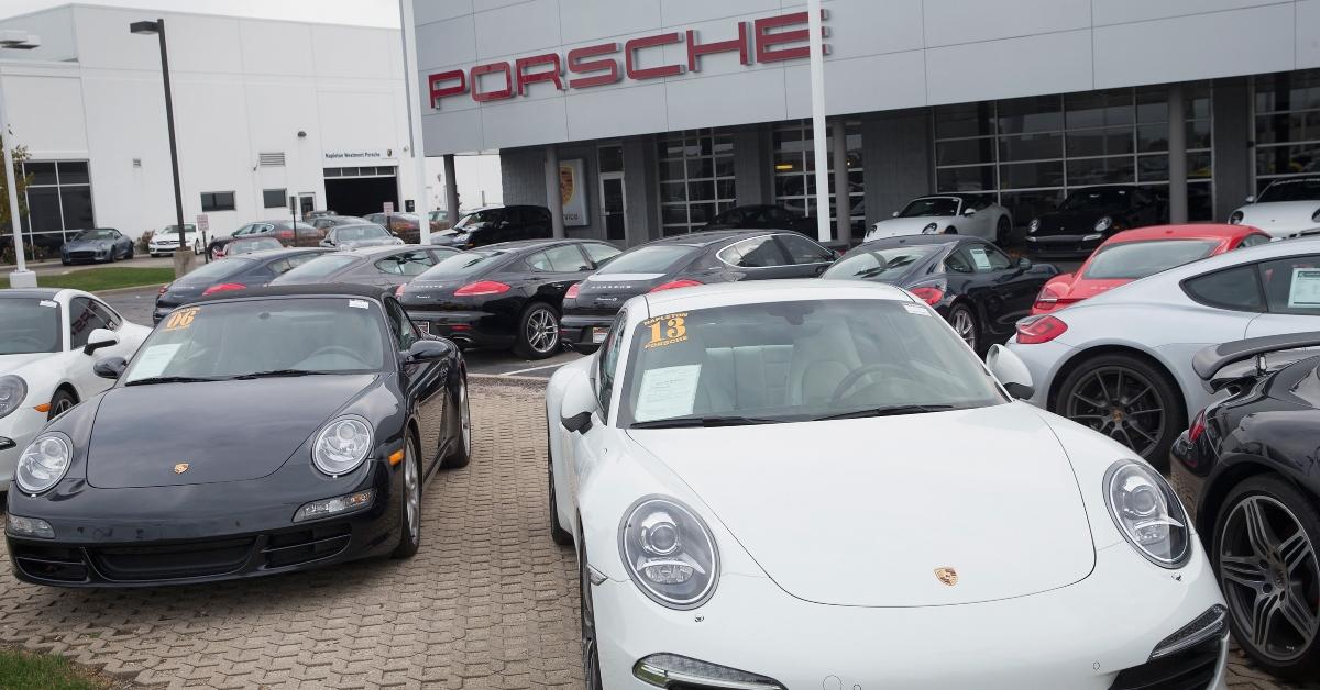 Cars parked at a Porsche dealership.