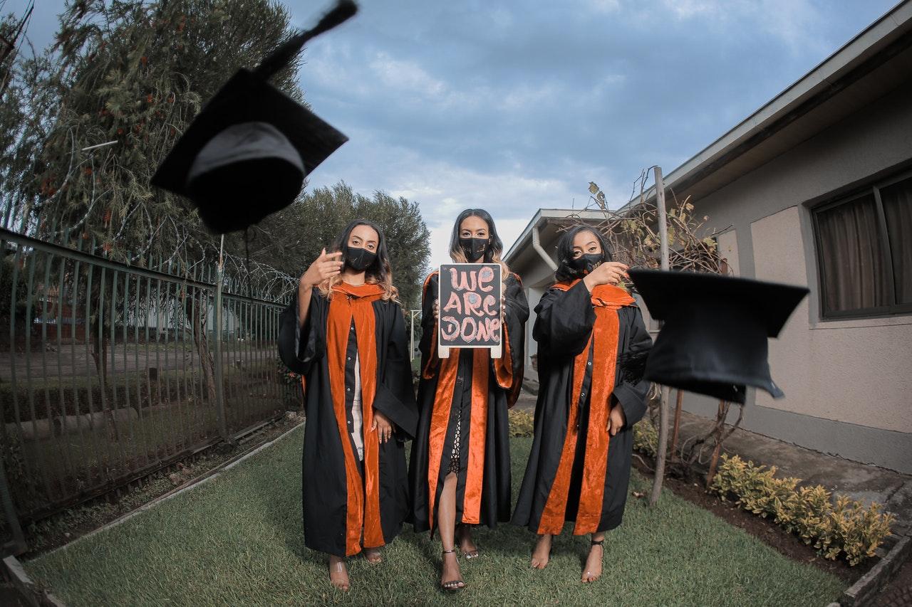 Graduates throwing their caps