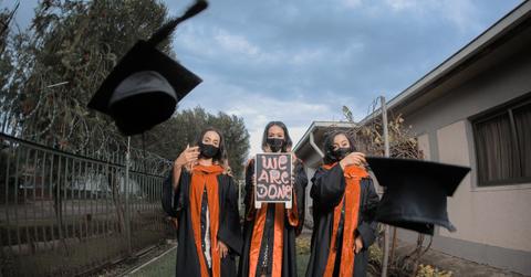 Graduates throwing their caps