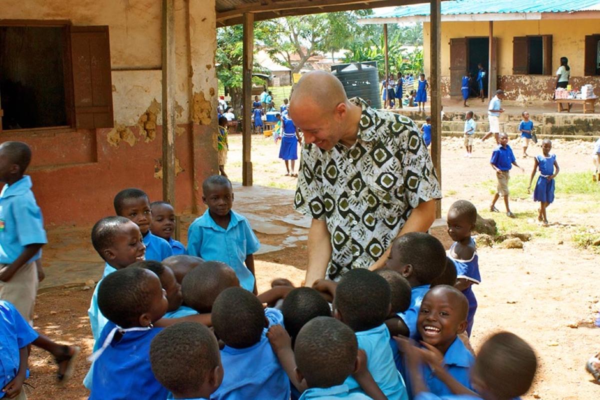 David Risher with students in Africa