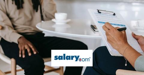 A person getting interviewed and the Salary.com logo