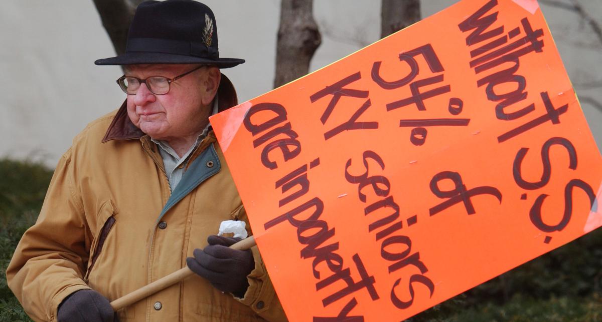 A man holding a sign protesting social security privatization