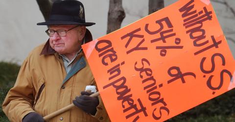 A man holding a sign protesting social security privatization