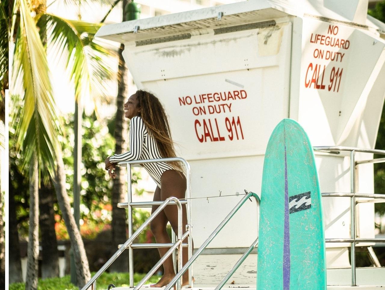 A person standing on a lifeguard platform