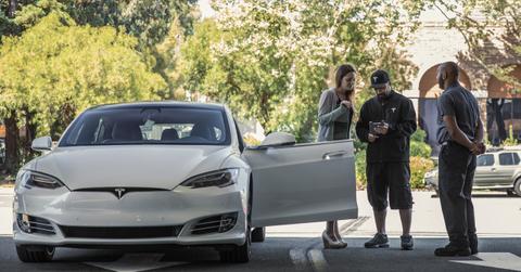 Tesla employees helping a customer