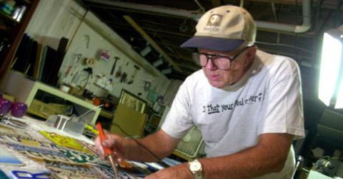 A man examining various license plates