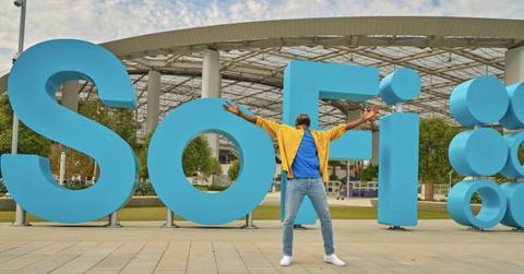 Man standing in front of a SoFi sign