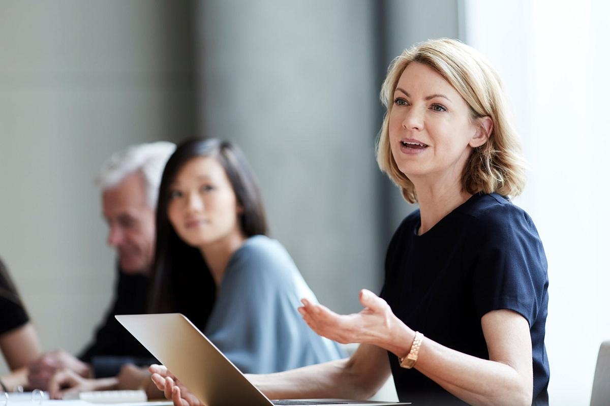 A person speaking at business meeting