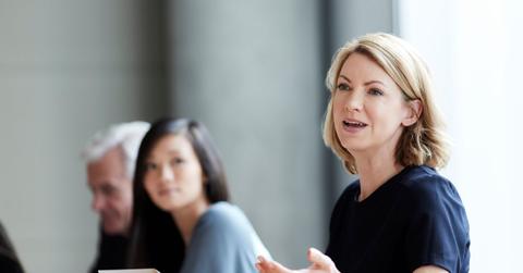 A person speaking at business meeting