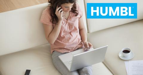 Woman talking on a phone and looking on a laptop and HUMBL logo