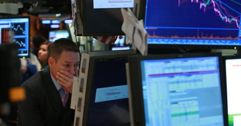 Worried trader looks on as stocks crash in recession