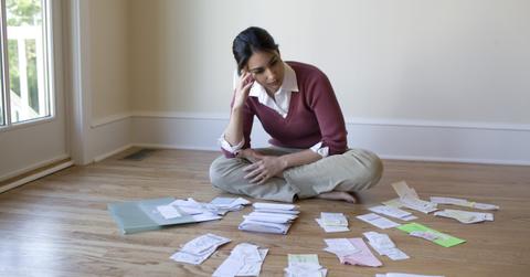 A woman looking at bills