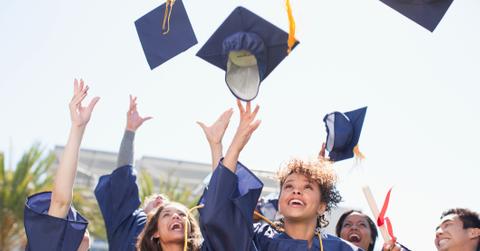 Students throwing mortarboards in the air