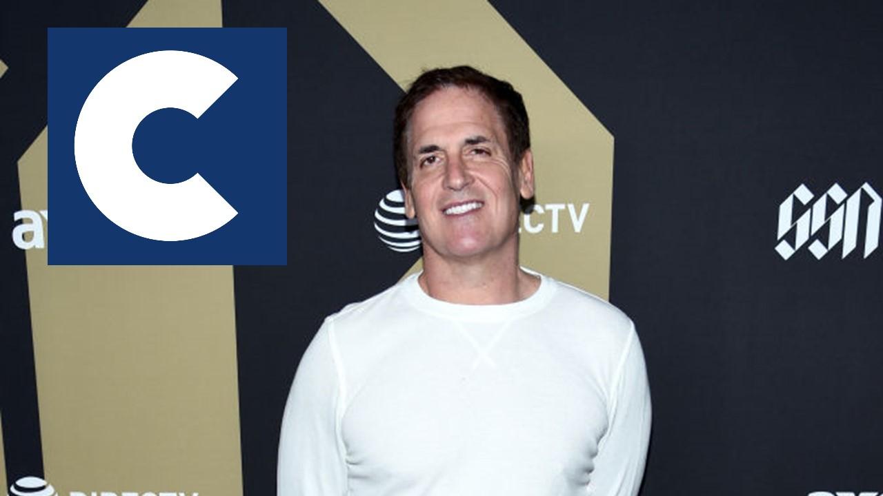 Mark Cuban at event in white shirt with Cost Plus Drugs logo