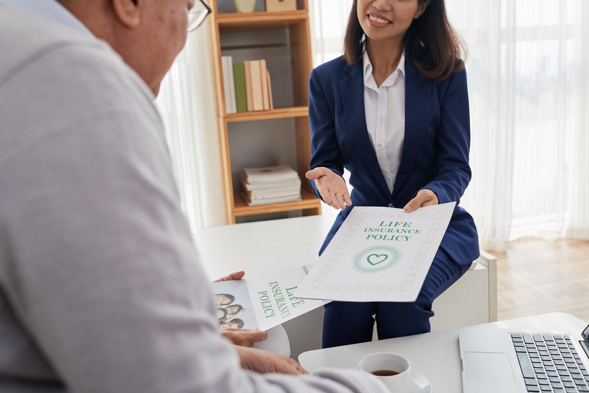 A person holding a life insurance document