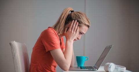 A student frowning at a laptop