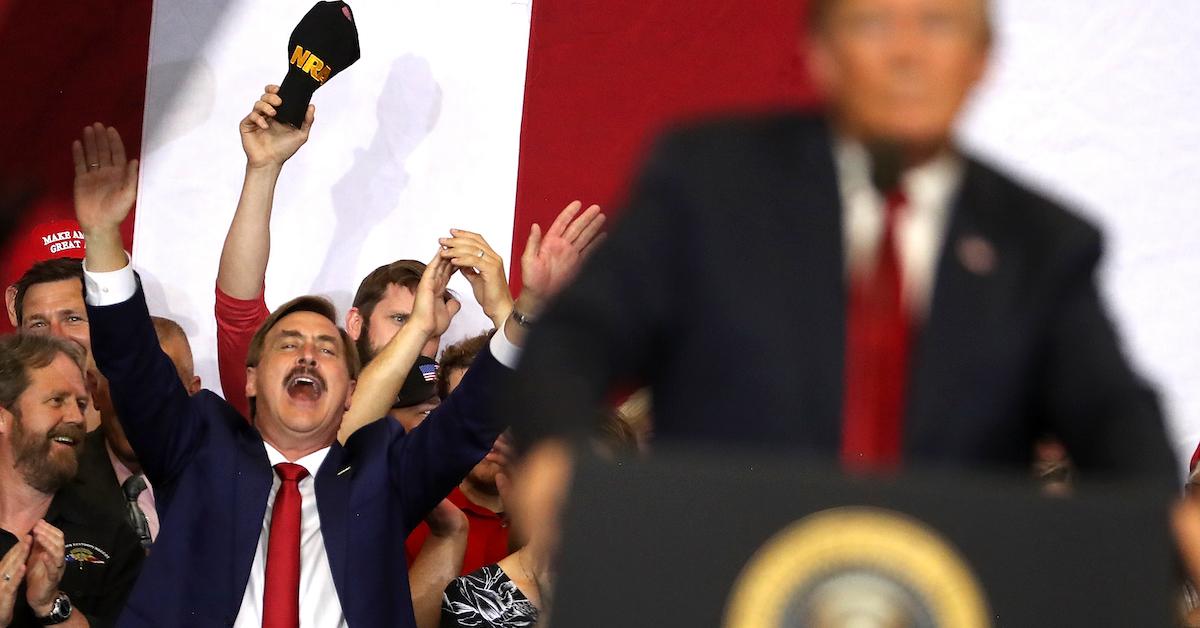 Mike Lindell pictured behind Donald Trump at a rally in Fargo, N.D., on June 27, 2018