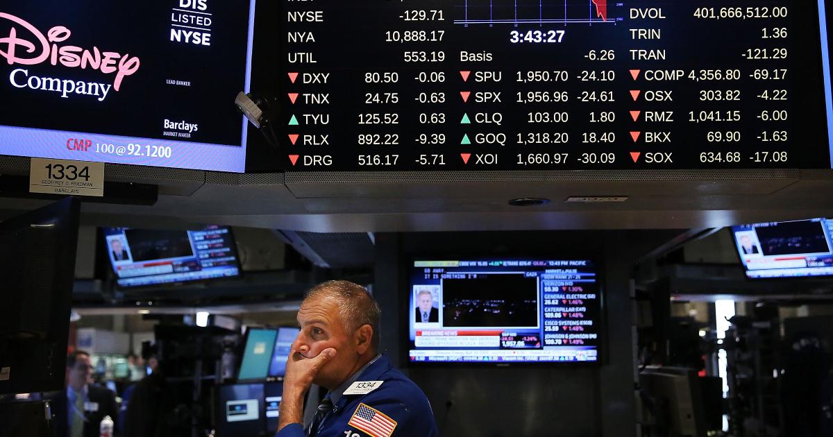 Trader looks at quotes as stocks crash