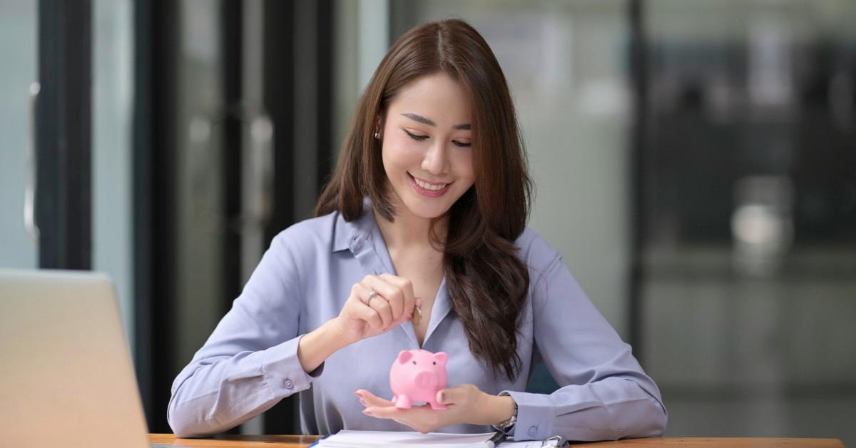 Woman using piggy bank