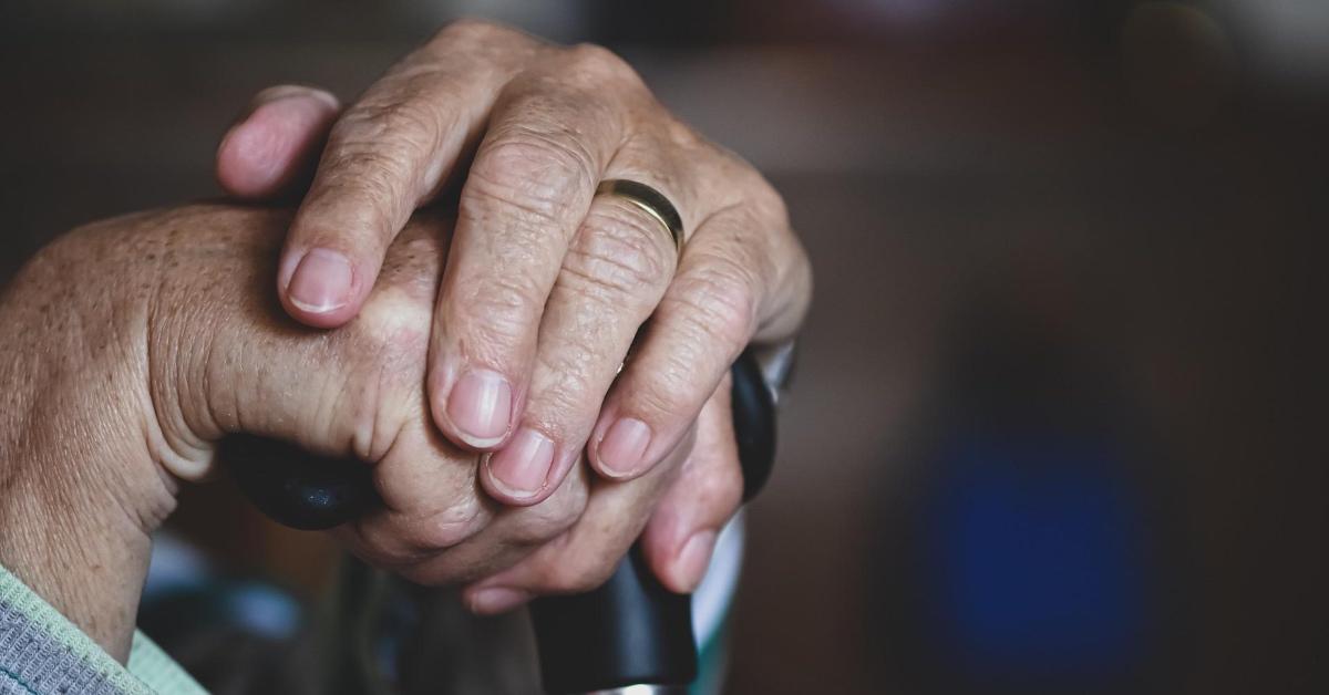 elderly person holding their cane