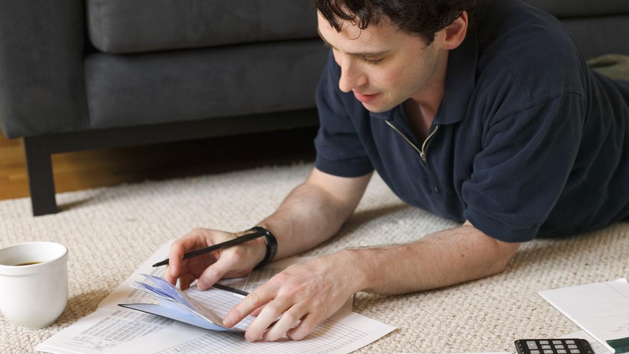 A man looking at student loan paperwork