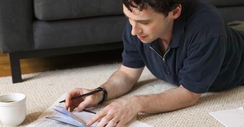 A man looking at student loan paperwork