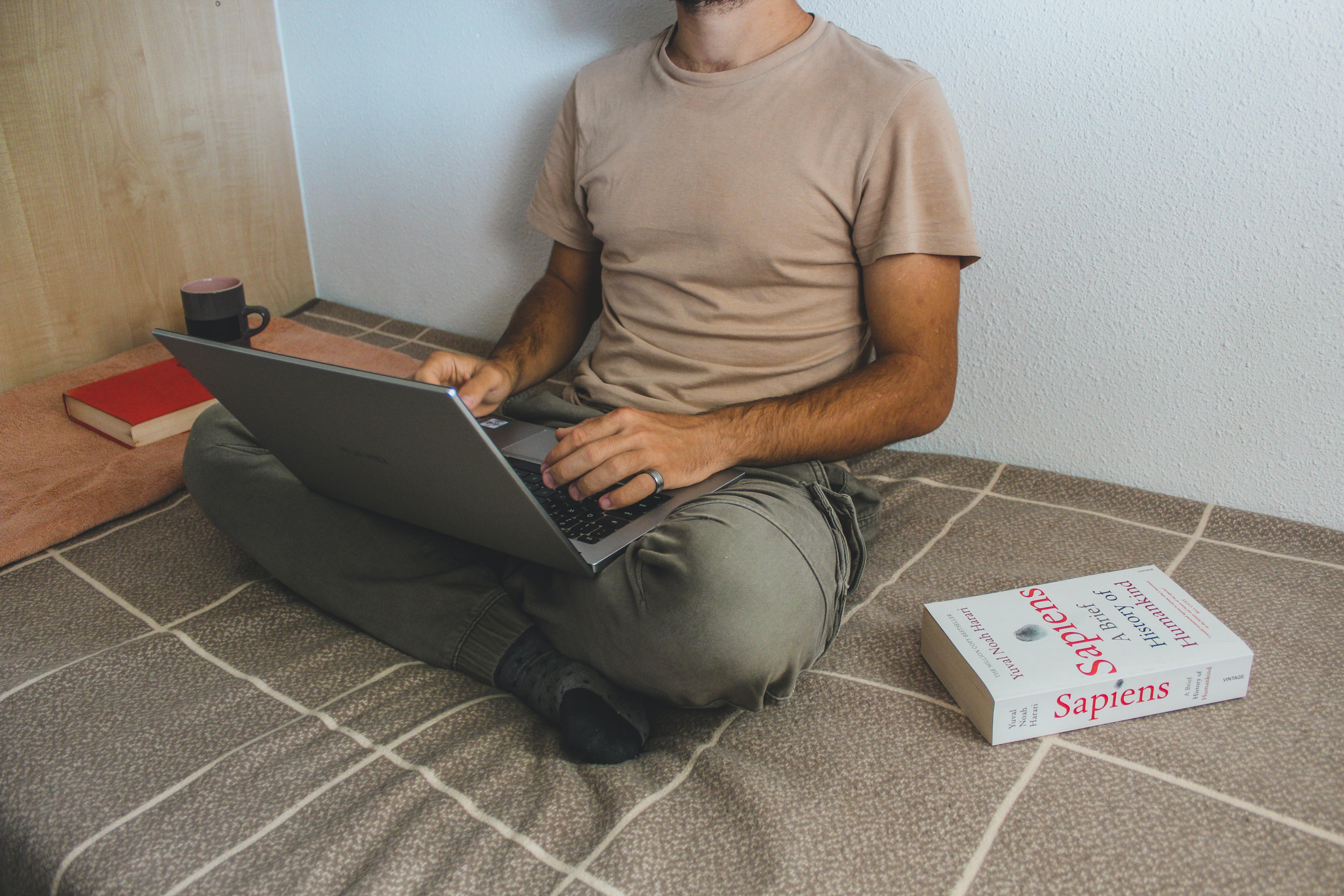 A student working on a laptop in their dorm room