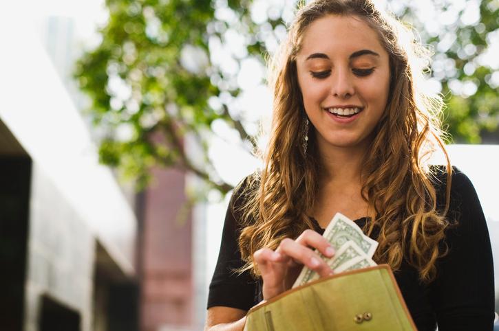 A woman checking how much cash is in her wallet