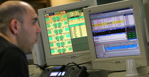 A forex trader looking at computer screens